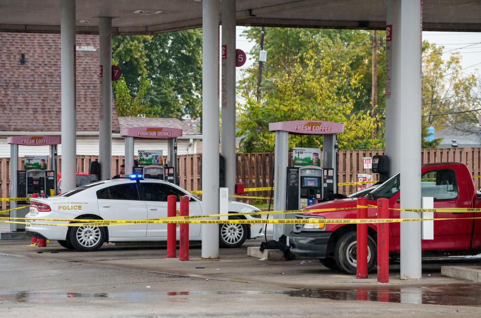 Law enforcement investigate Thursday, Oct. 19, 2023, after a man in a vehicle was shot at least once by Indianapolis Metropolitan Police Department officers near the intersection of Shelby and Raymond streets on the city's south side. Officers approached a man, who they say was armed and had a possible warrant, and gave him commands before at least one officer fired a weapon. Shelby Street will be closed for several hours from Raymond Street to LeGrande Avenue because of the shooting. Drivers are asked to find alternate routes.