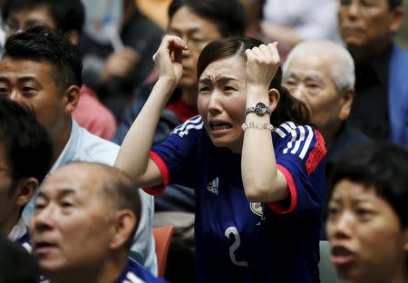 A Japan soccer fan reacts as she watches Japan's FIFA Women's World Cup final match against the U.S. in Vancouver, at a public viewing event in Tokyo, Japan, July 6, 2015. Japan lost the match 5-2 to the U.S. REUTERS/Toru Hanai