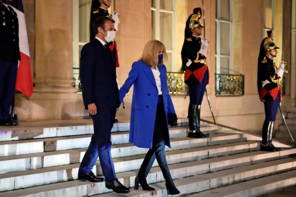 France’s President Emmanuel Macron, left, and his wife Brigitte Macron, welcome the Greek Prime Minister Kyriakos Mitsotakis and his wife Mareva Grabowski, prior to a dinner at the Elysee Palace, in Paris, Sept. 27. - Credit: AP