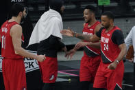 Portland Trail Blazers forward Norman Powell (24) and guard CJ McCollum, second from right, celebrate their win against the San Antonio Spurs with teammates Enes Kanter (11) and Carmelo Anthony, second from left, during the second half of an NBA basketball game in San Antonio, Friday, April 16, 2021. (AP Photo/Eric Gay)