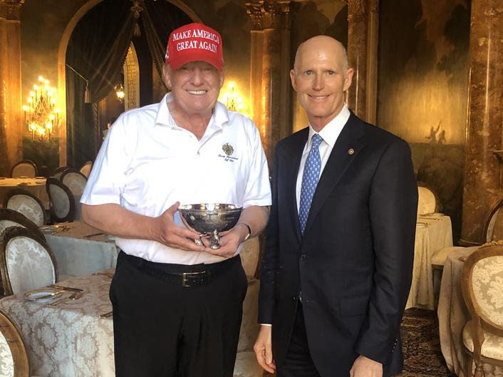 Sen. Rick Scott presents President Donald Trump with a tiny ceremonial bowl. (Photo: NRSC)