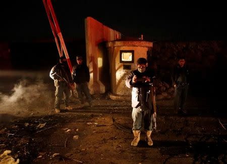 Afghan policemen inspect at the site of suicide bomb attack in Kabul, Afghanistan January 10, 2017. REUTERS/Omar Sobhani