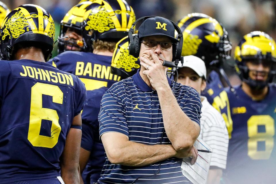 Michigan coach Jim Harbaugh watches replay as referees review a play during the first half of the Big Ten championship game on Saturday, Dec. 3, 2022, in Indianapolis.