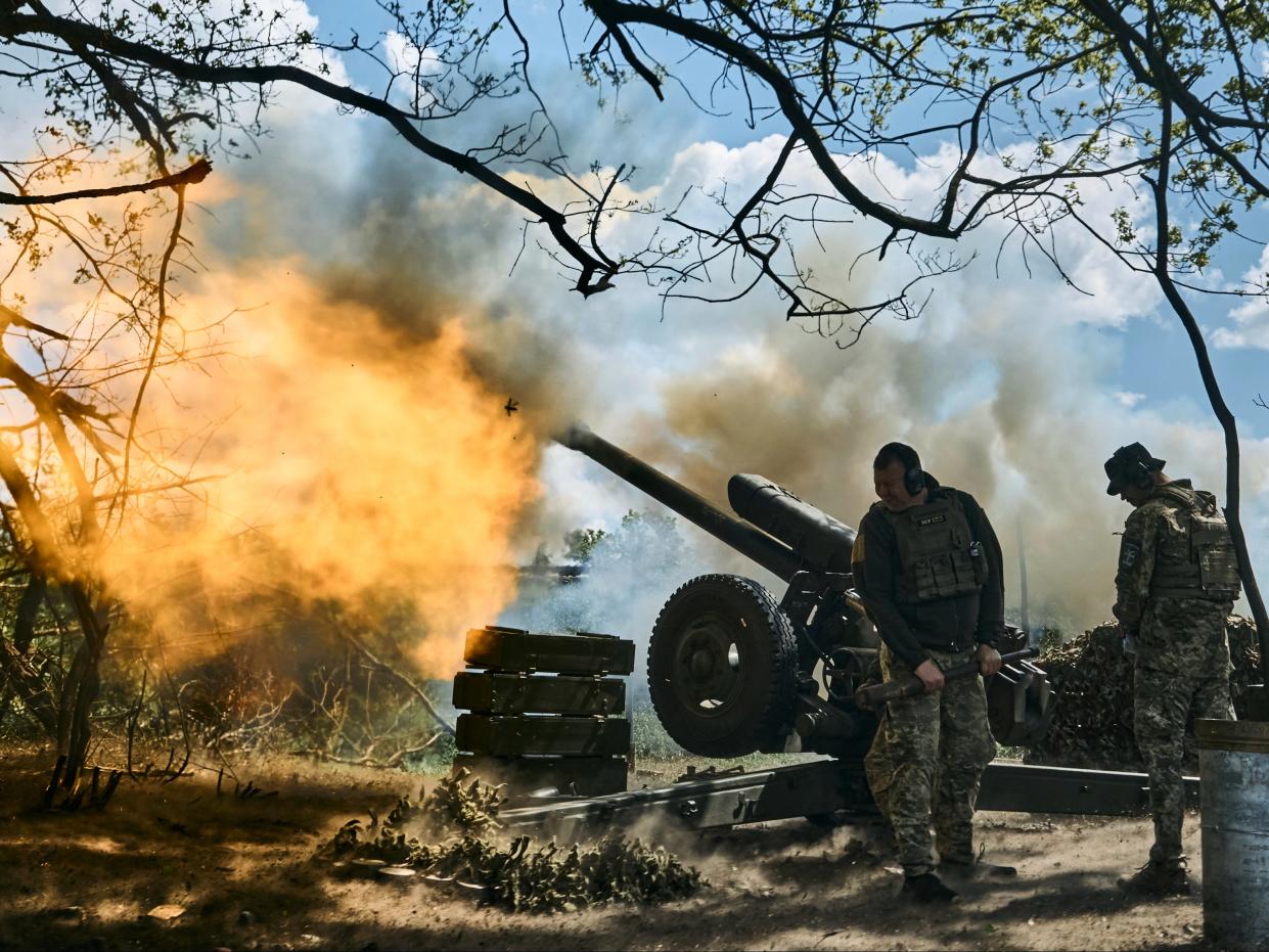 Ukrainian soldiers fire a cannon near Bakhmut, an eastern city where fierce battles against Russian forces have been taking place (AP Photo/Libkos)