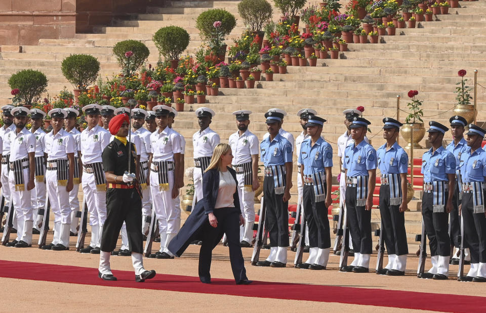 Italian Premier Giorgia Meloni, center, inspects a guard of honor during a ceremonial reception at the Indian Presidential Palace in New Delhi, India, Thursday, March 2, 2023. (AP Photo)