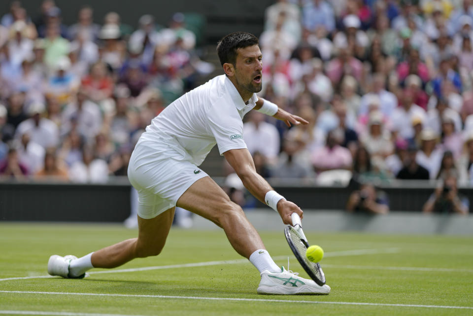 Serbia's Novak Djokovic returns to Italy's Jannik Sinner in a men's singles quarterfinal match on day nine of the Wimbledon tennis championships in London, Tuesday, July 5, 2022. (AP Photo/Alastair Grant)