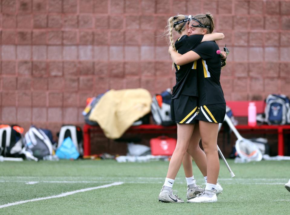 Honeoye Falls-Lima's Emma Hoffman (L) and Shaye Angelo embrace after losing 17-2 to Manhasset in the state Class C final.