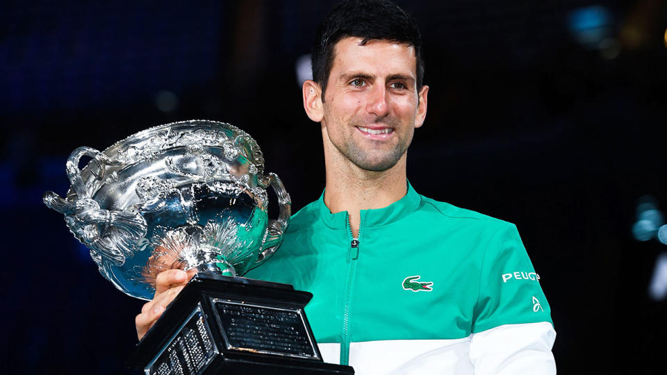 Pictured here, Novak Djokovic holds the Australian Open trophy aloft.