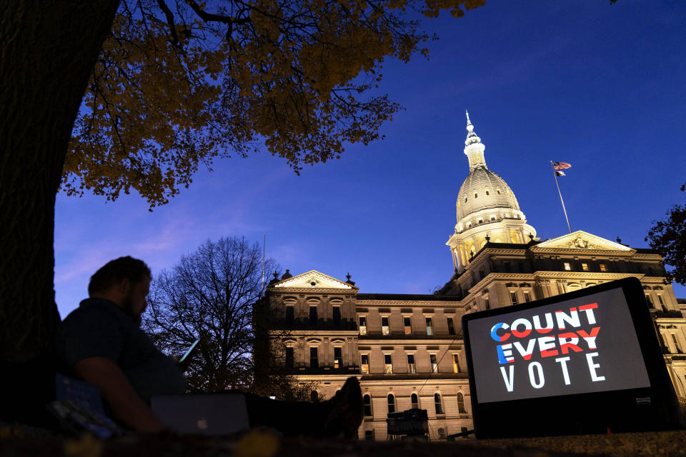 FILE - In this Nov. 6, 2020, file photo, the phrase "Count Every Vote" is displayed on a large screen, organized by an advocacy group in front of thesState Capitol while election results in several states had yet to be finalized, in Lansing, Mich. (AP Photo/David Goldman, File)