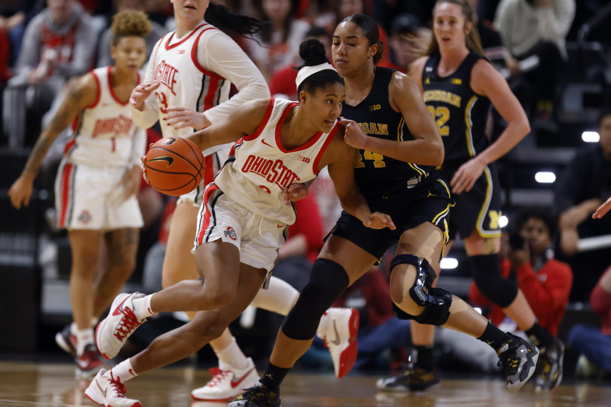 Ohio State guard Taylor Thierry, left, drives against Michigan forward Cameron Williams during a Big Ten women's college basketball game in Columbus, Ohio, on Dec. 31, 2022. (AP Photo/Paul Vernon)