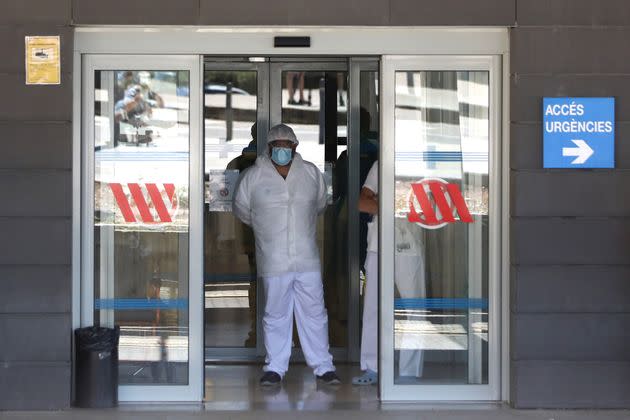 A health worker stands at the emergencies entrance of Arnau de Vilanova hospital, after Catalonia's government imposed new lockdown restrictions in Lleida.