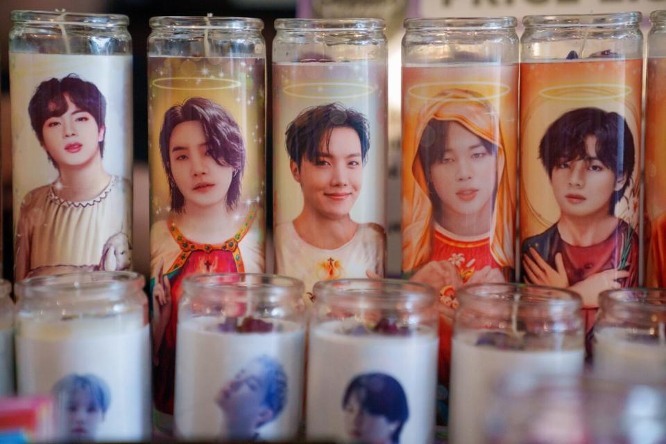 Votive candles featuring various K-pop stars.