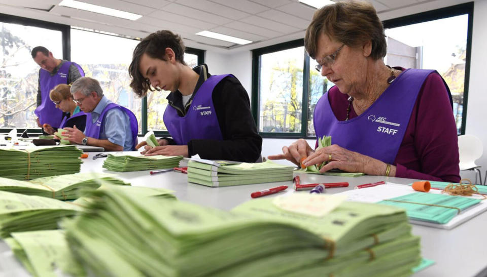 AEC employees pictured counting the votes in the  federal election. Source: Getty