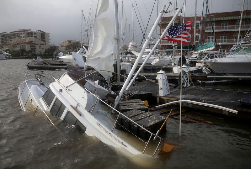 An U.S. flag flies from a boat damaged by Hurricane Sally in Pensacola