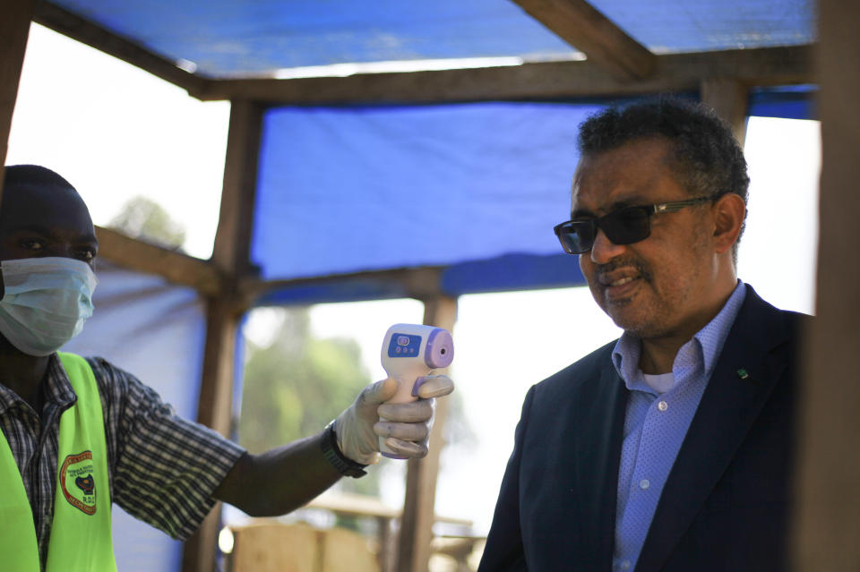 Director-General of the World Health Organization (WHO), Tedros Adhanom Ghebreyesus, right, has his temperature taken as he arrives at Ruhenda airport in Butembo, to visit operations aimed at preventing the spread of Ebola and treating its victims, in eastern Congo Saturday, June 15, 2019. The World Health Organization on Friday said the Ebola outbreak is an "extraordinary event" of deep concern but does not yet merit being declared a global emergency, a declaration that typically triggers more funding, resources and political attention. (AP Photo/Al-hadji Kudra Maliro)