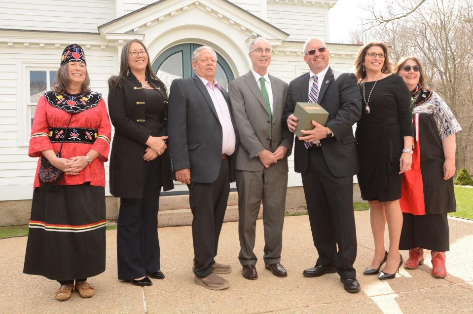 James Gessner jr., Mohegan tribal council chairman, third from right, holds a box of papers from the mid to late 1700s from Mohegan Rev. Samson Occom returned by Dartmouth College president Philip Hanlon, fourth from right, Wednesday during a repatriation ceremony at Mohegan Church. Joining them from left are Mohegan Chief Lynn Malerba, Beth Regan, vice chairwoman of the Mohegan Council of Elders, Charlie Strickland, council elders chairman, Sarah Harris, tribal council vice chairwoman and medicine woman Melissa Tantaquidgeon Zobel.