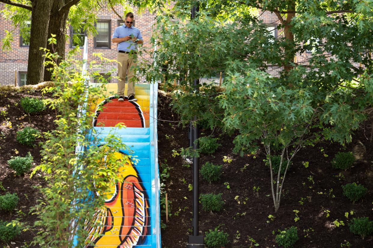 A new mural, depicting a koi fish, decorates a staircase near the intersection of 23rd Street and Ingersoll Avenue on Wednesday, June 21, 2023, in Des Moines. The mural, organized by The Avenues of Ingersoll & Grand, aims to boost walkability while contributing to a push in public art in the area. The koi fish was painted by Des Moines-based artists Jordan Sandquist and Chris Sullivan.