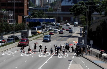 Protesters block the road at the Cross-Harbour Tunnel in Hong Kong