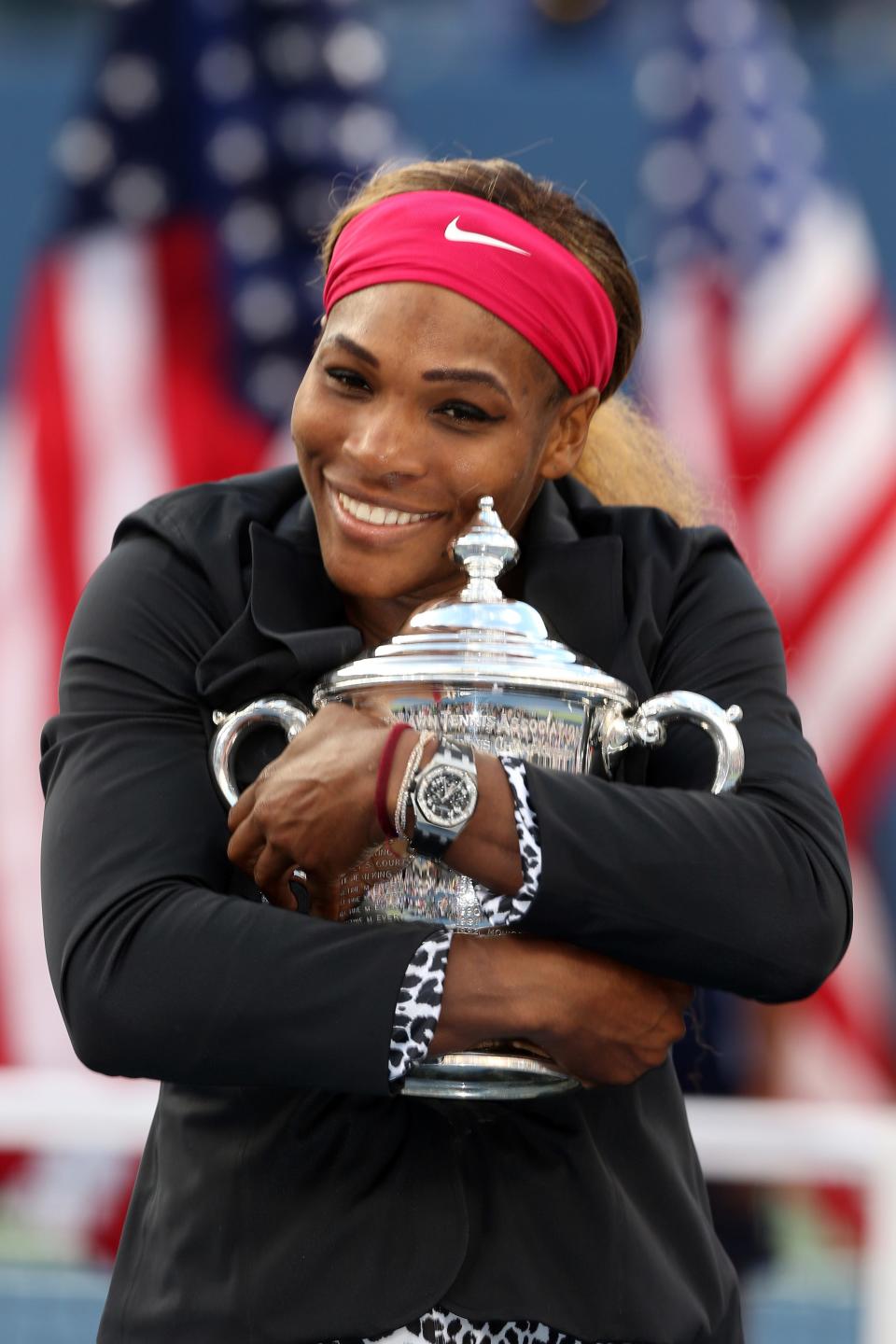 Serena Williams hugs her trophy after winning the 2014 US Open singles final.