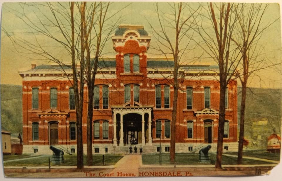 This colorized postcard of the Wayne County Courthouse in Honesdale depicts the two cannons that sat on the front lawn for 45 years. Each weighing around 9,700 pounds and 13 feet long, they saw service in the 1860s and 1870s. They were presented by the Department of the Navy in 1897 to the Civil War veterans' post in Honesdale (Captain James Ham Post 198, G.A.R.). The Post subsequently presented them to the county. In August 1942, the county commissioners agreed to donate them to the nationwide scrap drive to aid the World War II effort. Inscribed granite stones telling the cannons' service may be seen alongside the old stone jail near the courthouse.