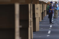 A poll worker stands alongside voter privacy booths during local and legislative elections, at a polling place in San Salvador, El Salvador, Sunday, Feb. 28, 2021. Sunday's elections in El Salvador are seen as a referendum on whether to break the congressional deadlock that has tied the hands of upstart populist President Nayib Bukele. (AP Photo/Salvador Melendez)