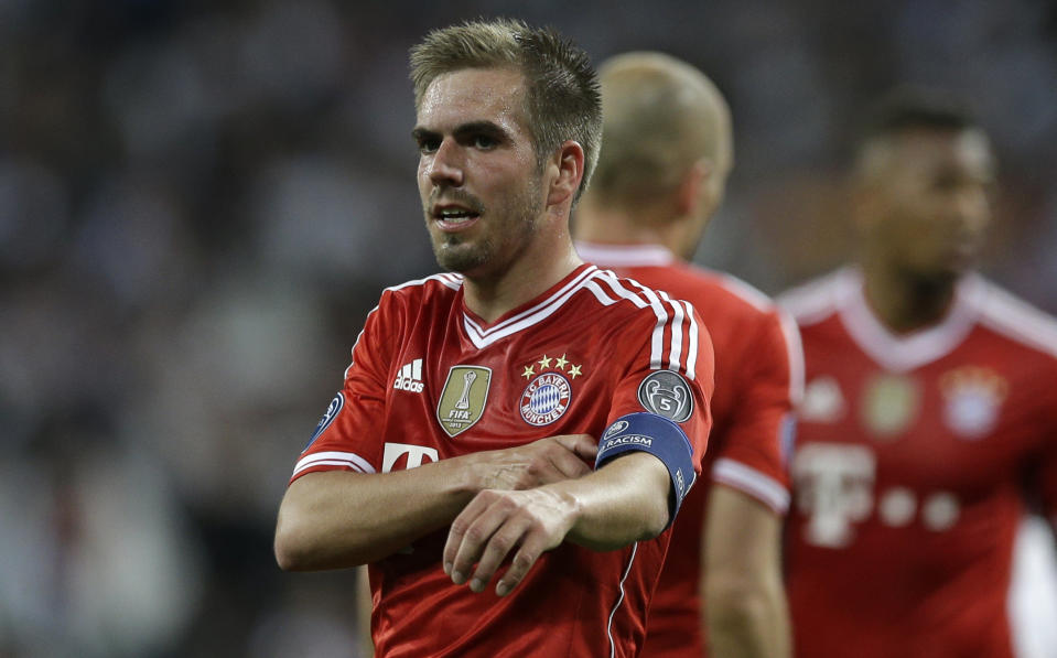 Bayern's Philipp Lahm takes off his armband after a Champions League semifinal first leg soccer match between Real Madrid and Bayern Munich at the Santiago Bernabeu stadium in Madrid, Spain, Wednesday, April 23, 2014. (AP Photo/Paul White)