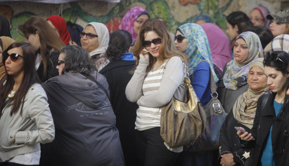 Egyptian voters line up outside a polling station in Cairo, Egypt, Tuesday, Jan. 14, 2014. Egyptians have started voting on a draft for their country's new constitution that represents a key milestone in a military-backed roadmap put in place after President Mohammed Morsi was overthrown in a popularly backed coup last July. (AP Photo/Amr Nabil)