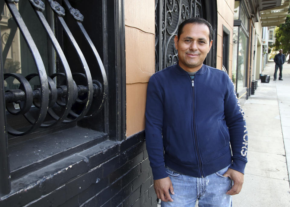 Fredy Ochoa stands in the Cole Valley district near his home Thursday, Oct. 4, 2018, in San Francisco. Fredy Ochoa, a 42-year-old Salvadoran immigrant in San Francisco, said he was relieved when he heard about the judge's ruling. He works in construction, has two American-born children and can't imagine returning to the country he left more than two decades ago as a teenager after a devastating civil war. "This is going to give us hope to continue in the fight for something better," Ochoa said in Spanish. "It is a huge relief." (AP Photo/Ben Margot)