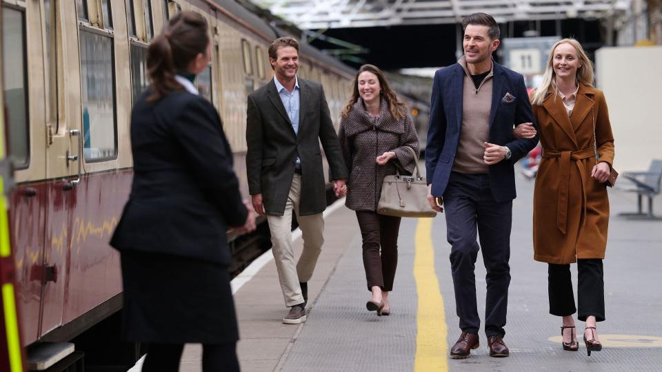 people boarding a steam train