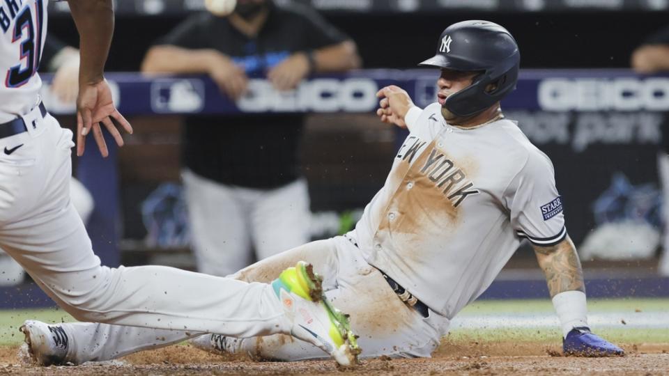 New York Yankees second baseman Gleyber Torres (25) slides at home plate and scores after a wild pitch by Miami Marlins relief pitcher Huascar Brazoban (31) during the fifth inning at loanDepot Park