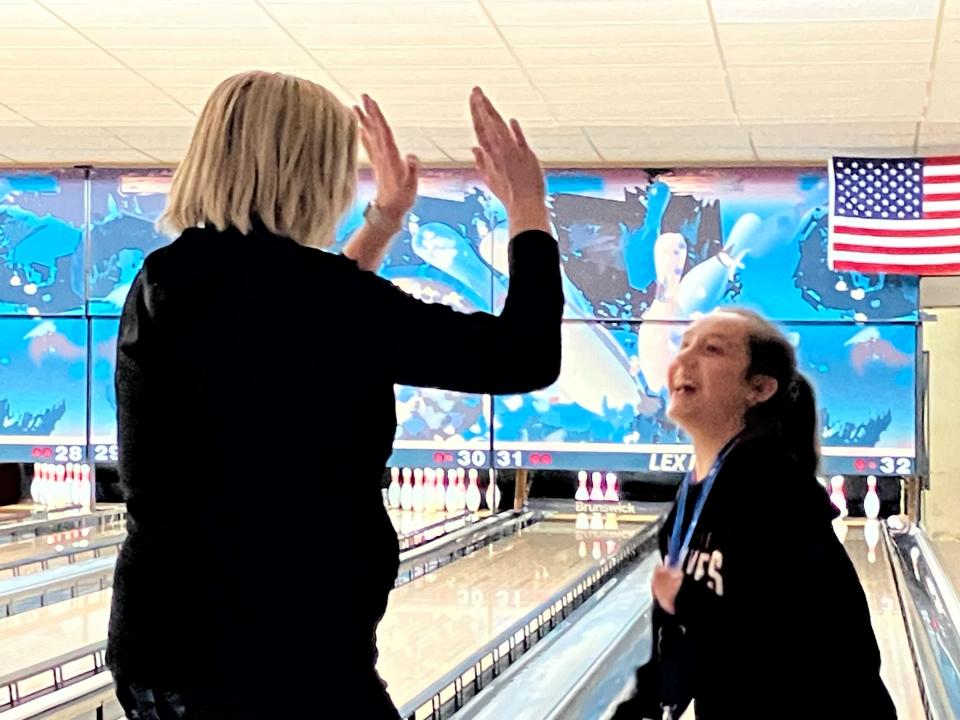 Mansfield City Councilwoman Stephanie Zader celebrates with Navaeh Patton, a fifth grader at Madison, Wednesday at Lex Lanes.