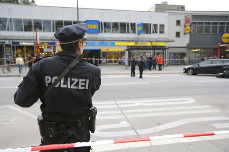 A police officer looks on after a knife attack in a supermarket in Hamburg, Germany, July 28, 2017. REUTERS/Morris Mac Matzen