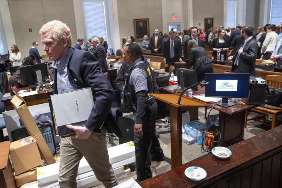 Alex Murdaugh, left, walks out of the courtroom during his double murder trial at the Colleton County Courthouse on Friday, Feb. 10, 2023, in Walterboro, S.C. The 54-year-old attorney is standing trial on two counts of murder in the shootings of his wife and son at their Colleton County home and hunting lodge on June 7, 2021. (Andrew J. Whitaker/The Post And Courier via AP, Pool)