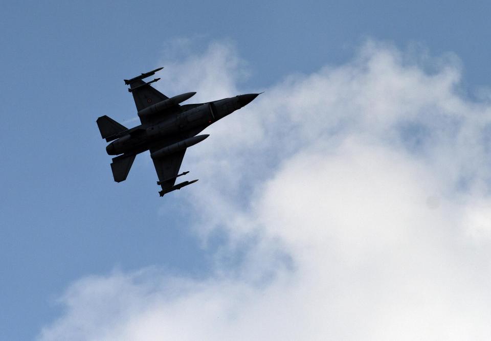 FILE - In this file photo taken Saturday, Aug. 31, 2013, a Turkish fighter jet flies above the Incirlik airbase, southern Turkey. Turkish fighter jets shot down a Syrian warplane after it violated Turkey's airspace Sunday, March 23, 2014, Turkish Prime Minister Recep Tayyip Erdogan said, in a move likely to ramp up tensions between the two countries already deeply at odds over Syria's civil war. (AP Photo/Vadim Ghirda, File)