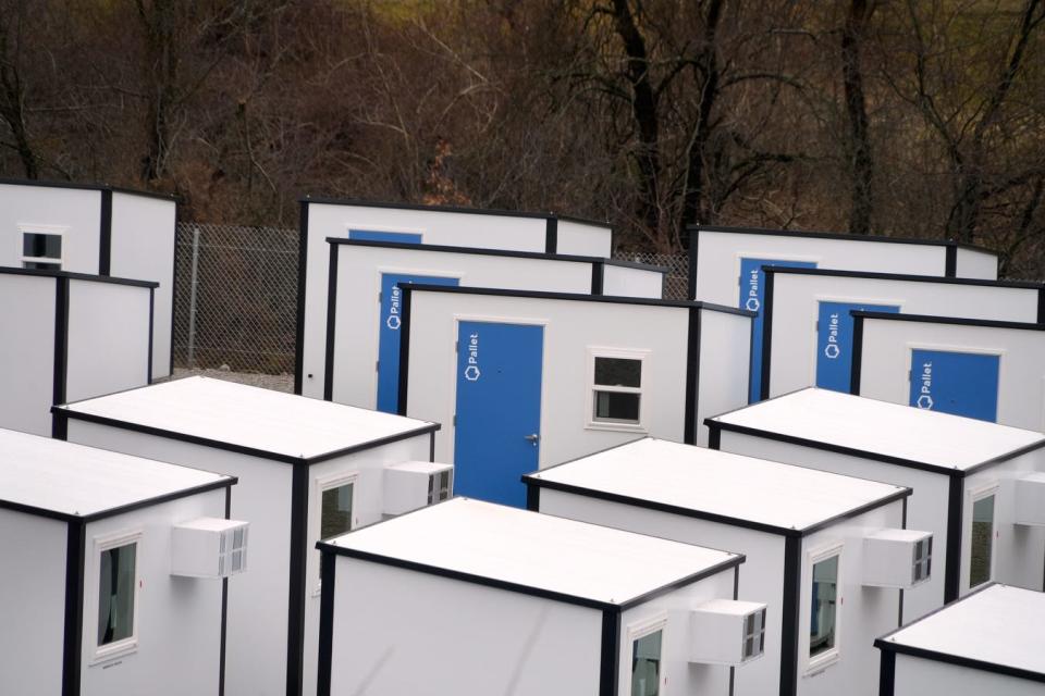 A closer view of the pallet shelters, at 70 square feet each roughly the size of a small cabin tent, showing the air conditioners high on the walls.