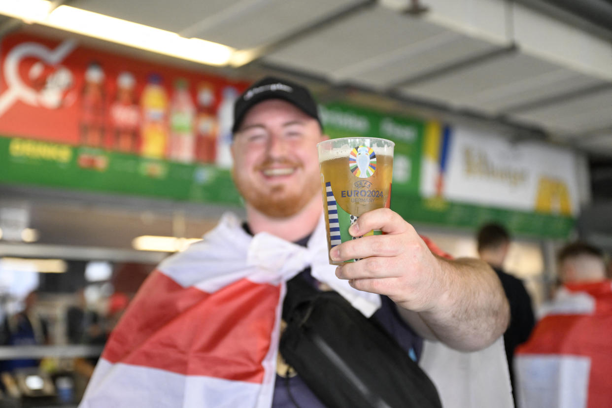 A supporter of England holds a reduced-strength beer prior to the UEFA Euro 2024 Group C football match between Serbia and England at the Arena AufSchalke in Gelsenkirchen on June 16, 2024. Gelsenkirchen has been declared high risk by the police due to fears Serbian ultras could clash with the tens of thousands of England fans that have made the trip to north-west Germany. (Photo by INA FASSBENDER / AFP)