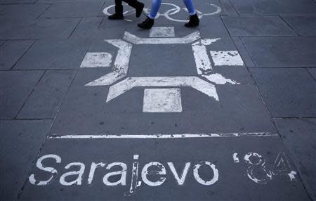 People walk past the logo of the Winter Olympics in Sarajevo, painted on the streets in central Sarajevo October 27, 2013. REUTERS/Dado Ruvic