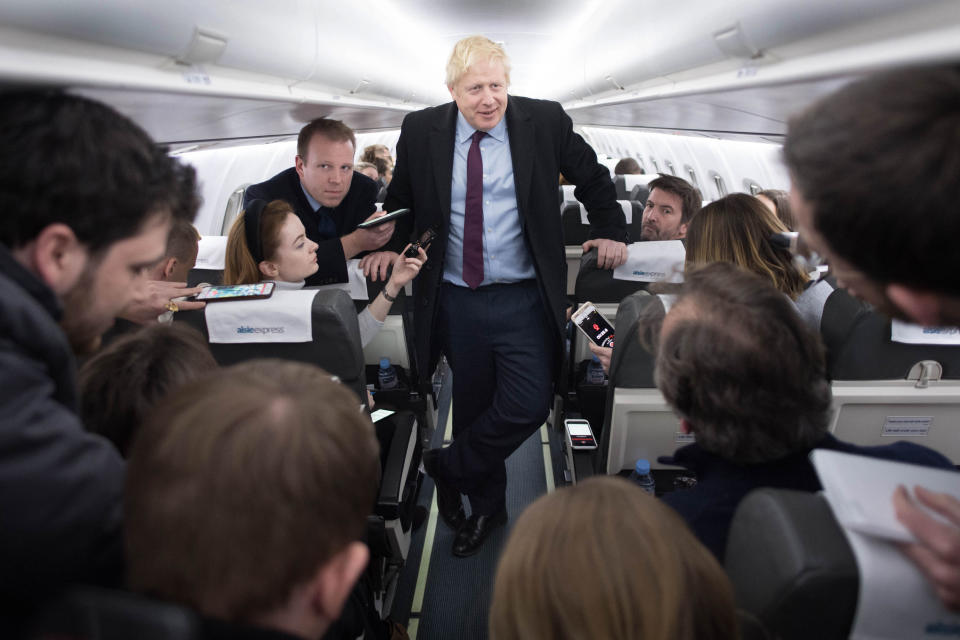 Prime Minister Boris Johnson speaks to the press on board his campaign plane whilst travelling to Birmingham after a day of visits in Grimsby and the north east. PA Photo. Picture date: Monday December 9, 2019. See PA story POLITICS Election. Photo credit should read: Stefan Rousseau/PA Wire