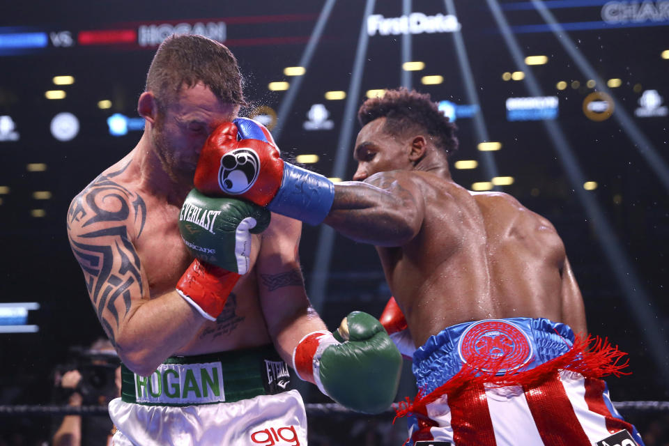 Jermall Charlo punches Ireland's Dennis Hogan during the fifth round of a WBC middleweight title boxing match Saturday, Dec. 7, 2019, in New York. (AP Photo/Michael Owens)