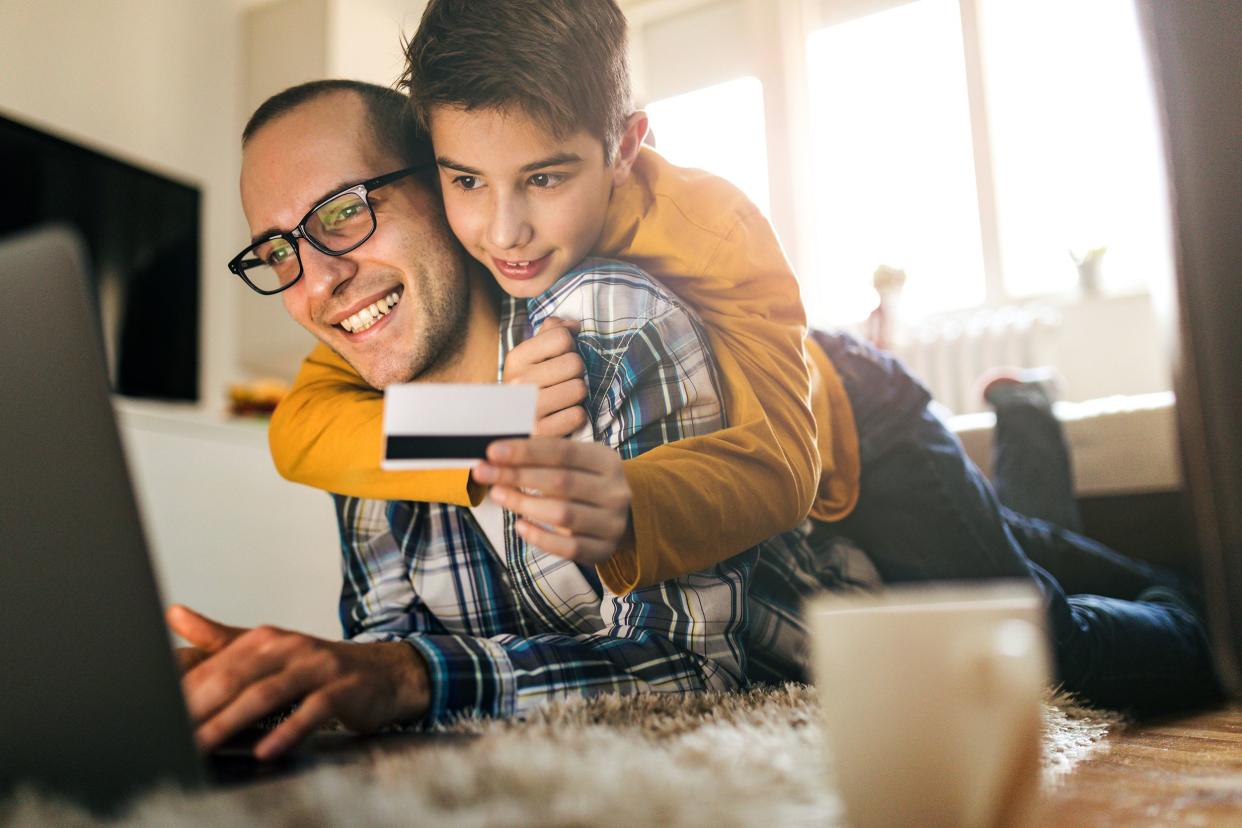 son and father shopping online with credit card