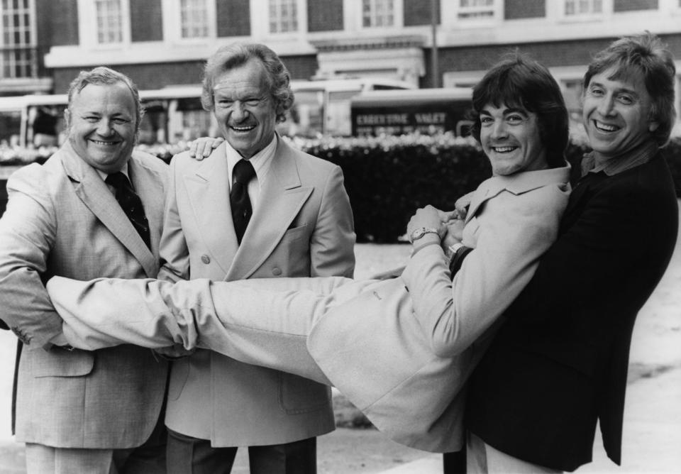 (From left) Singers and musicians Harry Secombe, Bert Weedon and Vince Hill holding up Bobby Crush at the launch of a new record company, Celebrity Records, London 1980