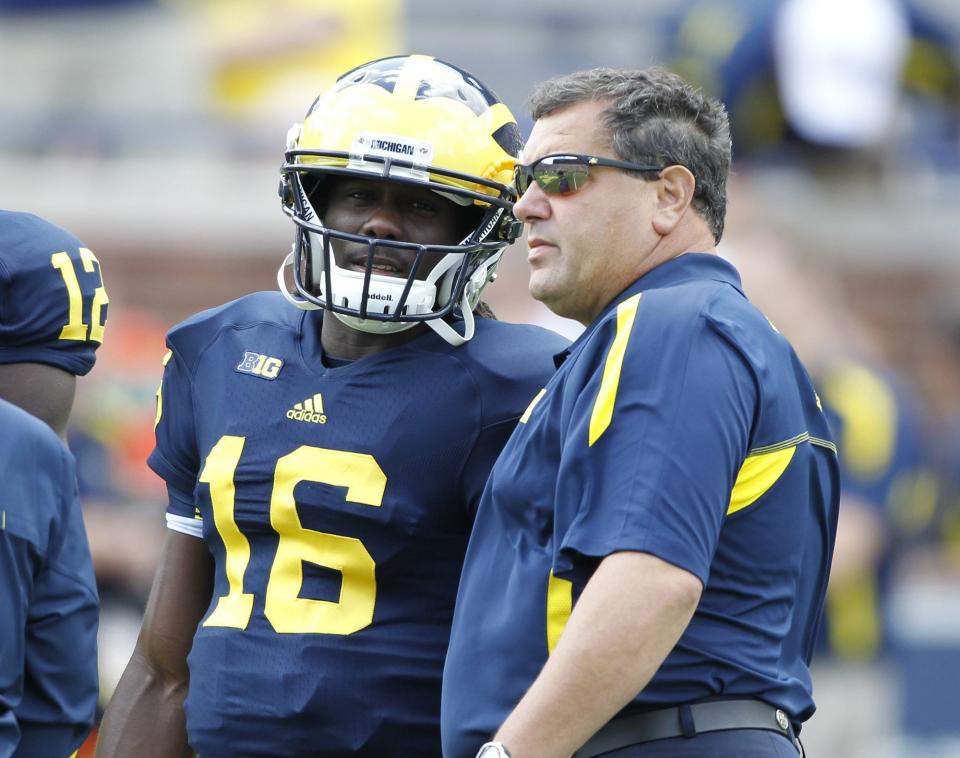 Denard Robinson talks with Brady Hoke during a game in Sept. 2012.