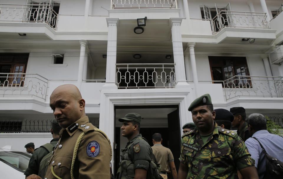 Sri Lankan security forces officers secure a site believed to be a hide out of the militants following a shoot out in Colombo, Sri Lanka, Sunday, April 21, 2019. More than hundred were killed and hundreds more hospitalized with injuries from eight blasts that rocked churches and hotels in and just outside of Sri Lanka's capital on Easter Sunday, officials said, the worst violence to hit the South Asian country since its civil war ended a decade ago. (AP Photo/Eranga Jayawardena)