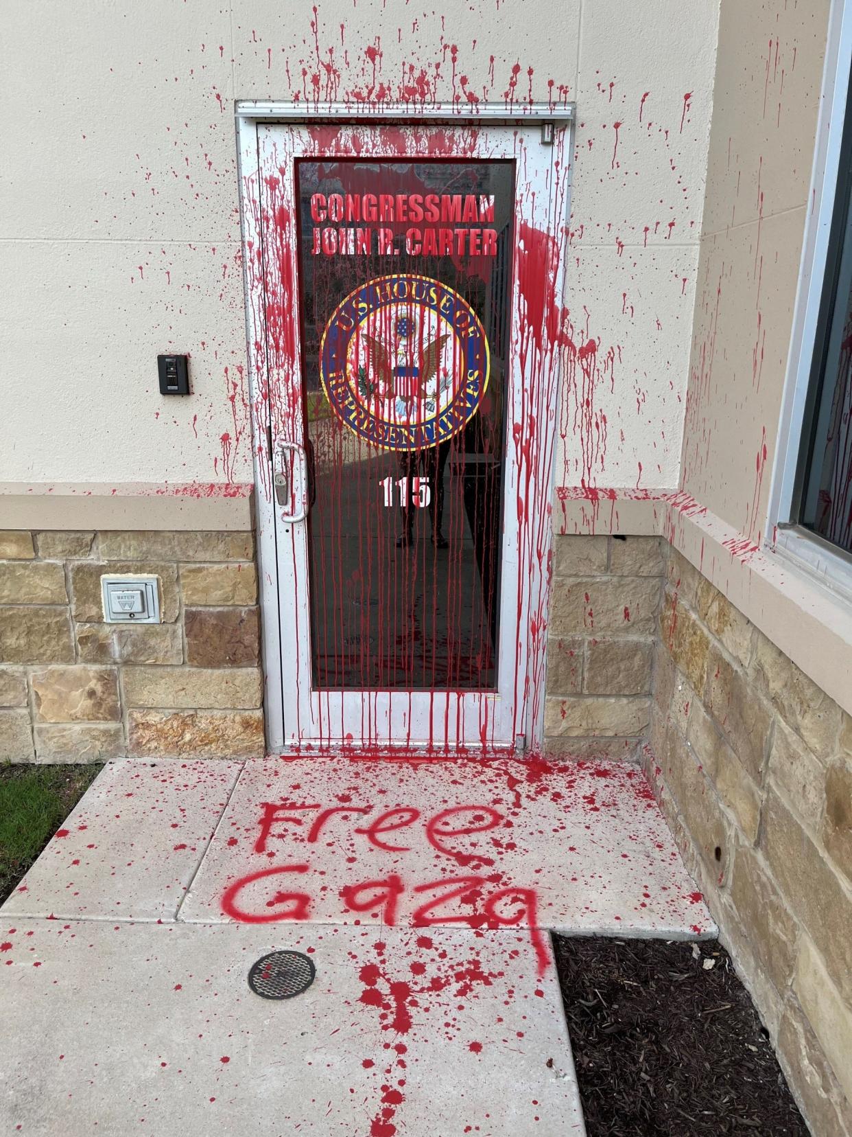 Police are looking for the person who threw red paint on the door and spraypainted 'Free Gaza' outside U.S. Rep. John Carter's office in Georgetown.