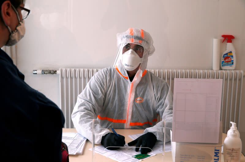 FILE PHOTO: A French doctor wearing a protective suit works in a testing site for the coronavirus disease (COVID-19) in Gouzeaucourt,