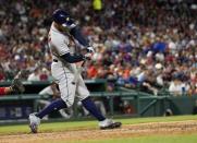 Apr 20, 2019; Arlington, TX, USA; Houston Astros right fielder George Springer (4) hits a two-run home run against the Texas Rangers during the seventh inning of a baseball game at Globe Life Park in Arlington. The Rangers won 9-4. Mandatory Credit: Jim Cowsert-USA TODAY Sports