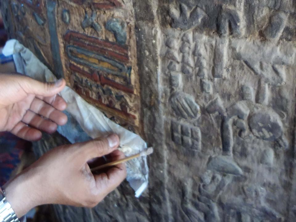 A picture of someone restoring frescas in the temple of Esna.