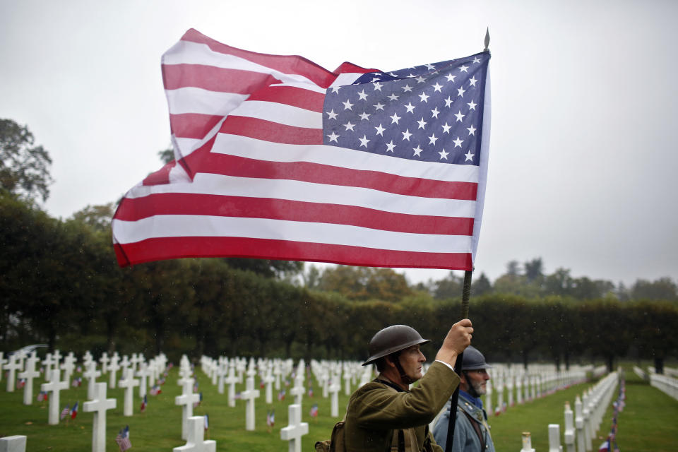 Men in WWI military uniforms pose in the Meuse-Argonne cemetery, northeastern France, during a remembrance ceremony, Sunday, Sept. 23, 2018. A remembrance ceremony is taking place Sunday for the 1918 Meuse-Argonne offensive, America's deadliest battle ever that cost 26,000 lives but helped bringing an end to World War 1. (AP Photo/Thibault Camus)