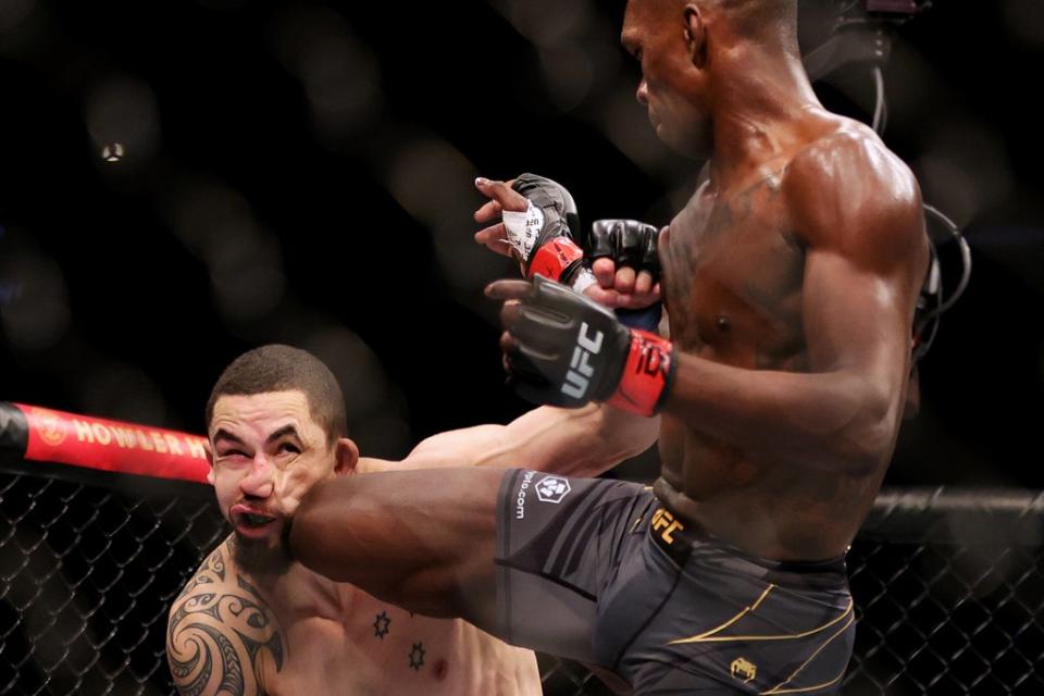 Middleweight champion Adesanya lands a kick on Whittaker (Getty Images)