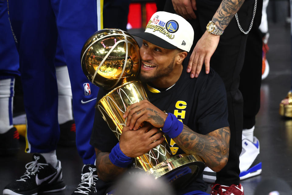 Gary Payton II of the Golden State Warriors celebrates with the Larry O'Brien Championship Trophy after defeating the Boston Celtics 103-90 in Game Six of the 2022 NBA Finals at TD Garden on June 16, 2022 in Boston.